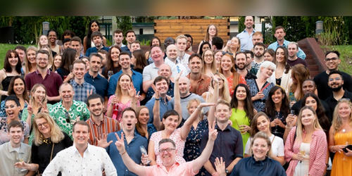 Group shot of the Opinium agency team smiling 